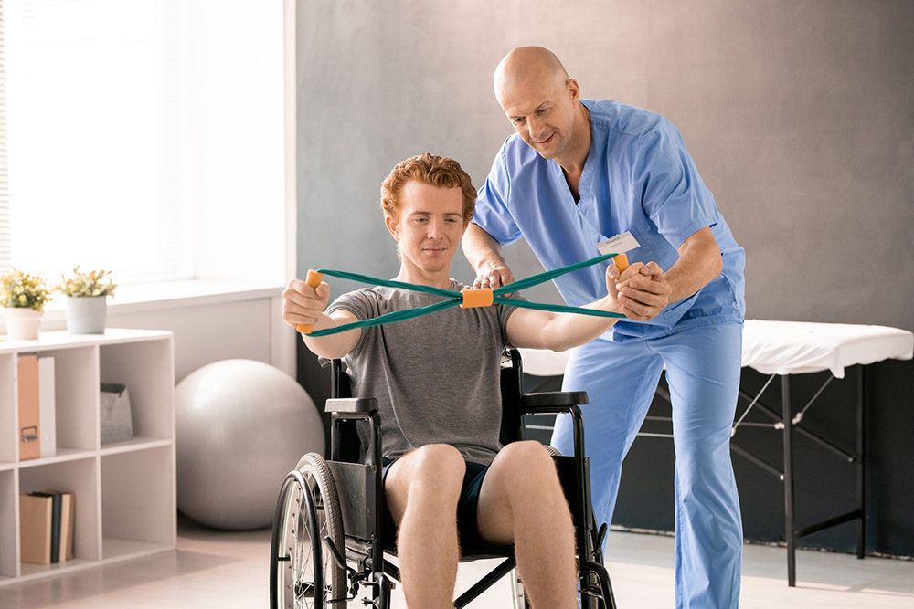 Disabled individuals with trainer working out.